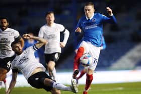 Ronan Curtis is challenged by Peterborough captain Mark Beevers, as Nathan Thompson, left, gives chase