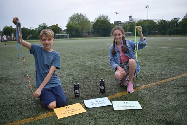 Ollie Arthur and Grace Scholes with their rainbow beads after finishing the run.