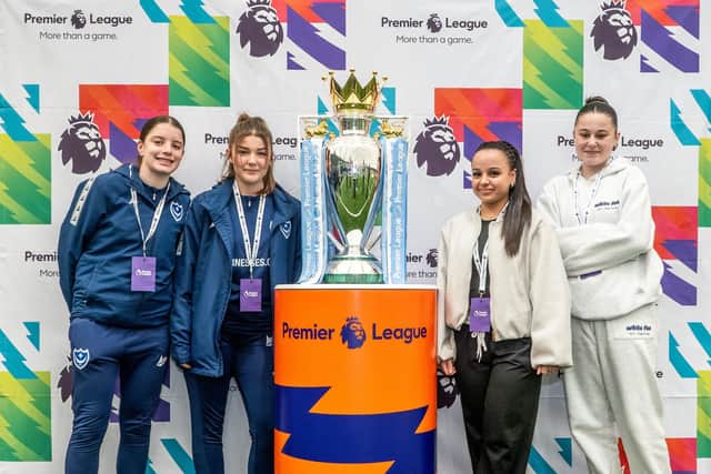 Pompey's Premier League Changemakers participants with the Premier League trophy in Wolverhampton