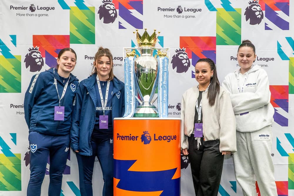 Pompey's Premier League Changemakers participants with the Premier League trophy in Wolverhampton