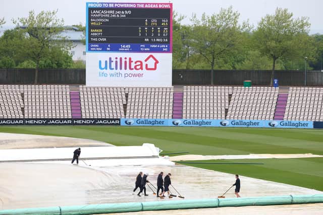 Groundstaff sweep water off the cover as rain delays play during day four of the LV= Insurance County Championship match between Hampshire and Lancashire at The Ageas Bowl. Photo by Michael Steele/Getty Images.