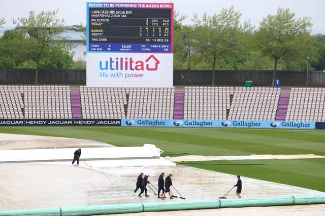 Groundstaff sweep water off the cover as rain delays play during day four of the LV= Insurance County Championship match between Hampshire and Lancashire at The Ageas Bowl. Photo by Michael Steele/Getty Images.