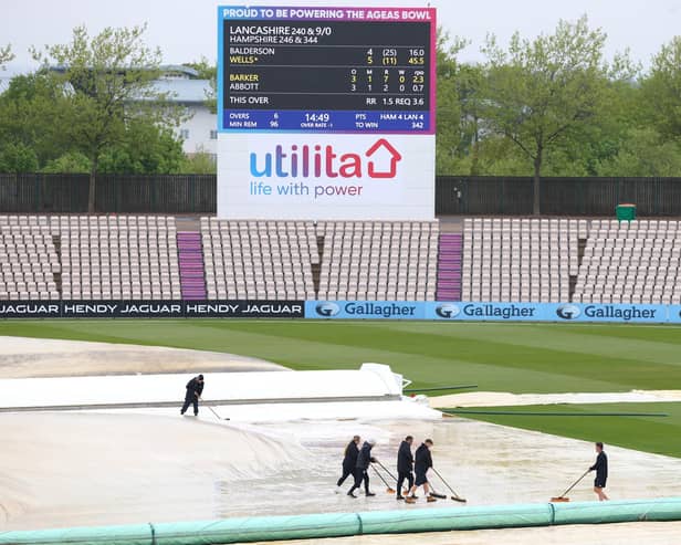 Groundstaff sweep water off the cover as rain delays play during day four of the LV= Insurance County Championship match between Hampshire and Lancashire at The Ageas Bowl. Photo by Michael Steele/Getty Images.