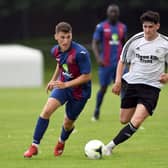 Brodie Spencer (left) on the ball for US Portsmouth during their Wessex League win against Portland last month. Picture: Neil Marshall.