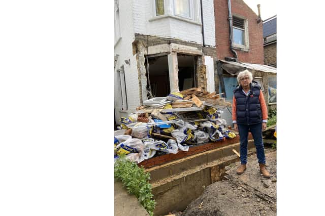 Tatiana Dent in front of her wrecked home