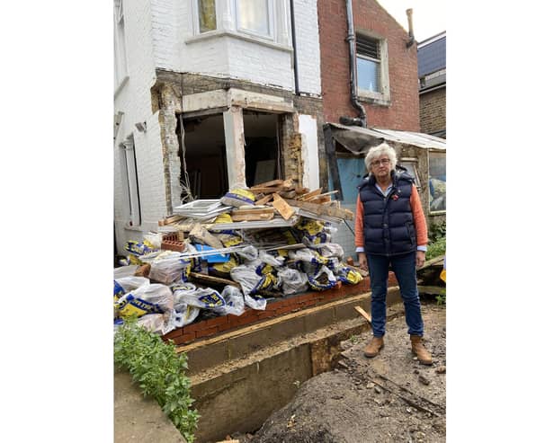 Tatiana Dent in front of her wrecked home