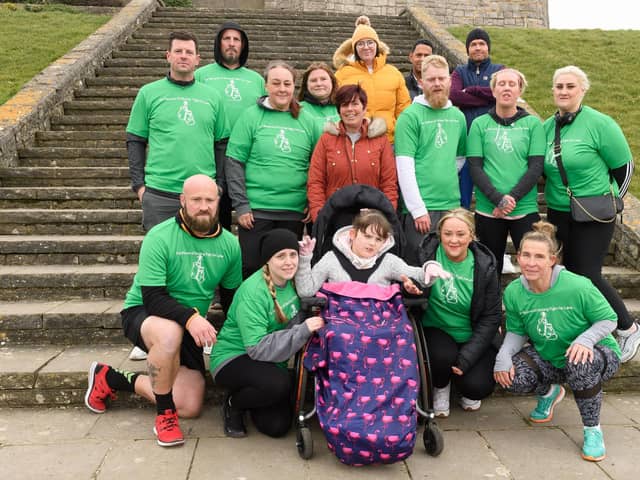 Pictured is: Lana with those fundraising for her.Picture: Keith Woodland (060321-9)