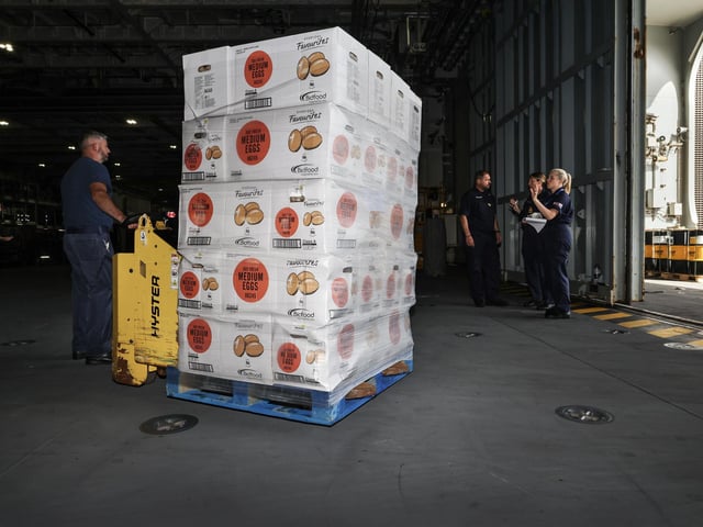 Pictured: A palette of eggs is loaded onto the ship.