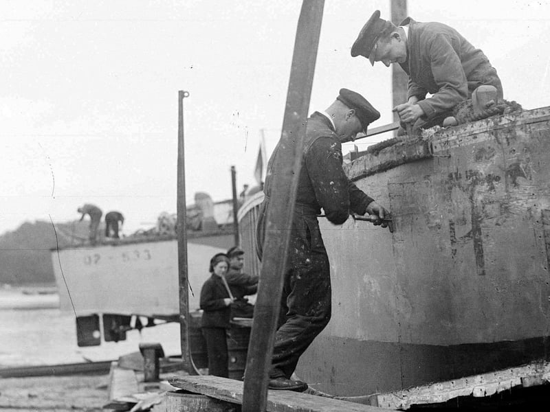 Men and women working on landing craft