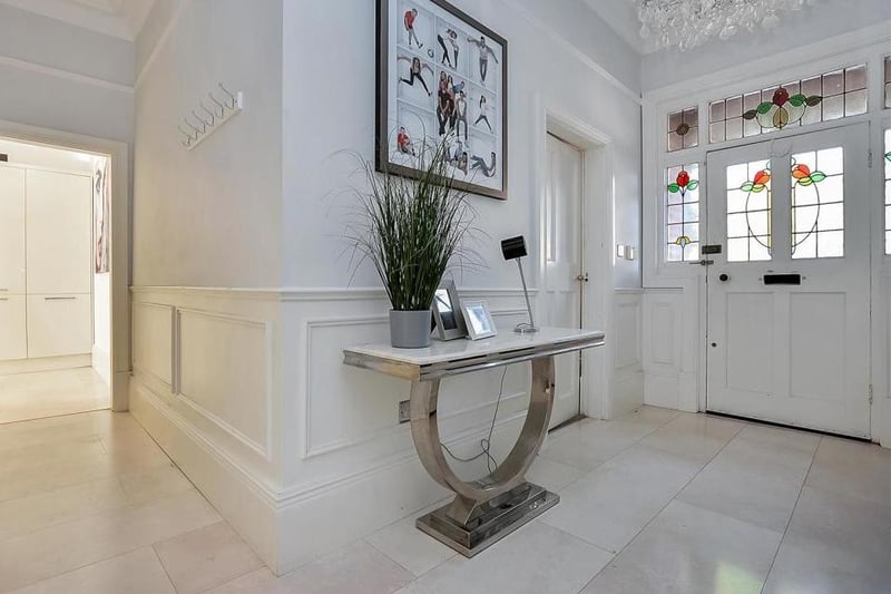 A stone-arched porch with Victorian tiles leads to the front door. Turn the key and find this welcoming entrance hall, which gives you an immediate idea of the scale of the property, with high skirting boards, wall boarding and ceiling roses.