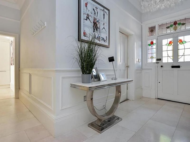 A stone-arched porch with Victorian tiles leads to the front door. Turn the key and find this welcoming entrance hall, which gives you an immediate idea of the scale of the property, with high skirting boards, wall boarding and ceiling roses.