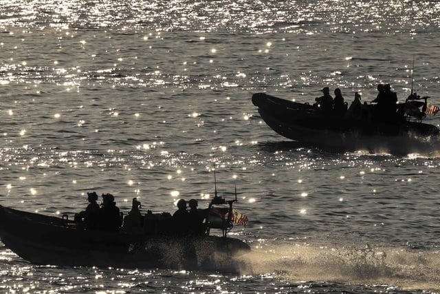 HMS Dauntless' embarked Law Enforcement Detachment (LEDET) leave the ship in sea boats in preparation to apprehending a suspect vessel in the Caribbean Sea.