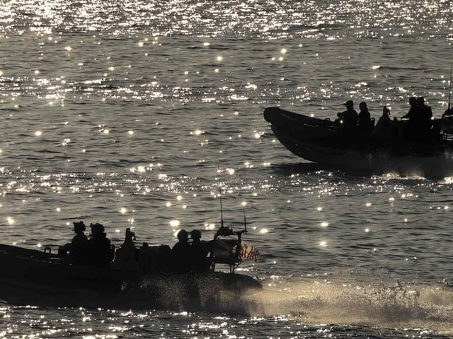 HMS Dauntless' embarked Law Enforcement Detachment (LEDET) leave the ship in sea boats in preparation to apprehending a suspect vessel in the Caribbean Sea.