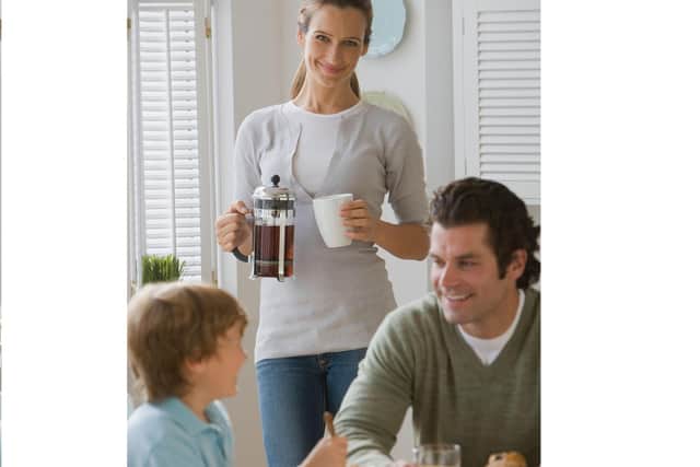 A couple with their young son. PA