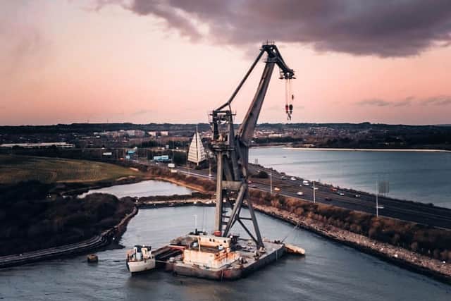 The Pompey Dinosaur meets Tipner shipwreck after Storm Eunice. Picture: Ade Whitehall/ Instagram @adetakesphotos