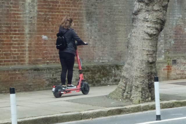 A Voi scooter being rode on the pavement on Ordnance Road, Portsea in May 2022