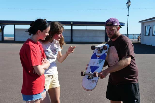 Jacob Skinner of the Portsmouth Skate Academy teaches a couple of his students on Clarence Esplanade, Southsea