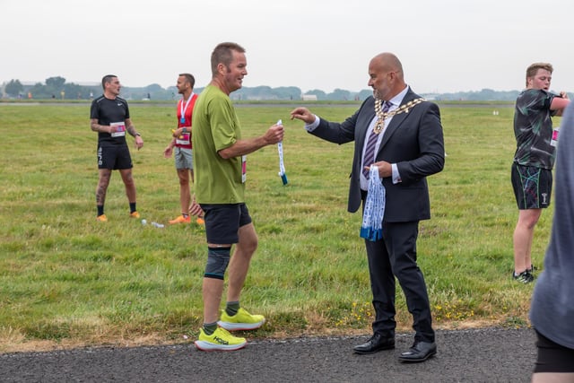Councillor Fred Birkett (Mayor of Fareham) presents a medal to a participant of the Run The Runway event. 

Picture: Mike Cooter