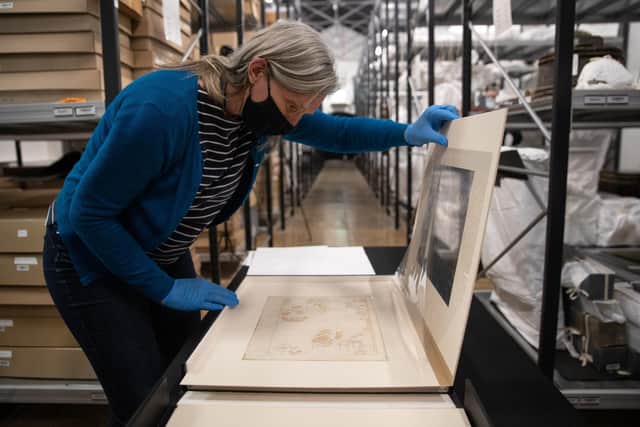 Victoria Ingles, senior curator at the National Museum of the Royal Navy, looks at one of the 'Armada Maps' at Portsmouth Historic Dockyard. Photo: Andrew Matthews/PA Wire