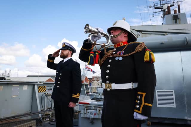 The White Ensign is lowered on-board HMS Echo as RM Bugler plays the last post during her decommissioning ceremony held in HMNB Portsmouth.