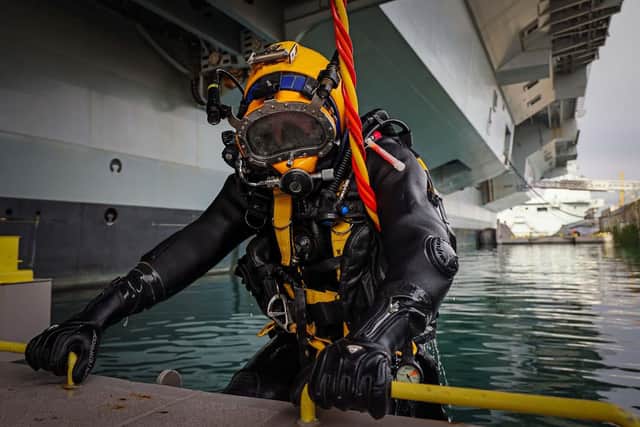 Royal Navy Divers are carrying out work on the hull of HMS Prince of Wales whilst the ship is alonside in HMNB Portsmouth, Hampshire on 10th February 2022.