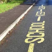 Photo showing a yellow warning sign with zig-zags saying School Keep Clear. Getty Images