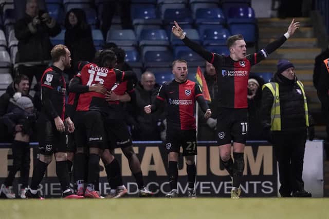 Skipper Ronan Curtis and his Pompey team-mates celebrate after their last-gasp 1-0 win at Gillingham on Saturday. Picture: Jason Brown/ProSportsImages