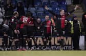Skipper Ronan Curtis and his Pompey team-mates celebrate after their last-gasp 1-0 win at Gillingham on Saturday. Picture: Jason Brown/ProSportsImages