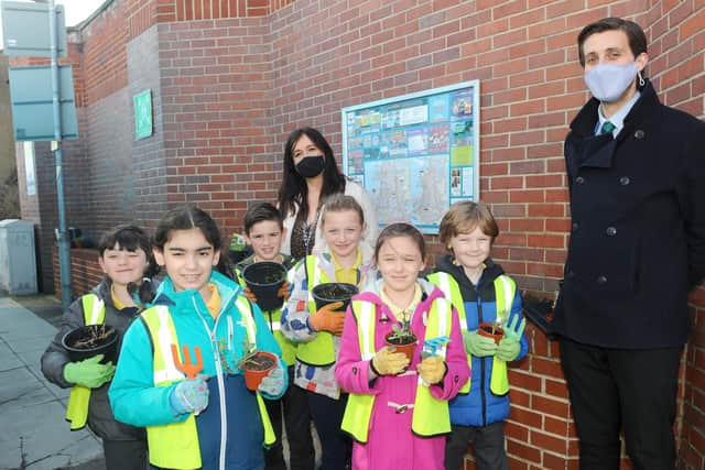 Year 2 pupils from Bramble Infant School and Nursery in Southsea, planted flowers outside the Co-op in Fawcett Road, Southsea, on Tuesday, March 23, as part of the Wilder Portsmouth scheme.

Pictured is: (back) Sarah Mayell-Thomas, Year 2 teacher with (right) headteacher Oli Bradley and pupils (l-r) Luca Melis (7), Zeynep Yalcin (6), Ethan Bevan-Davies (7), Layla Staley (7), Lorelei Sullivan (7) and Wesley Purslove (7). 

Picture: Sarah Standing (230321-5314)