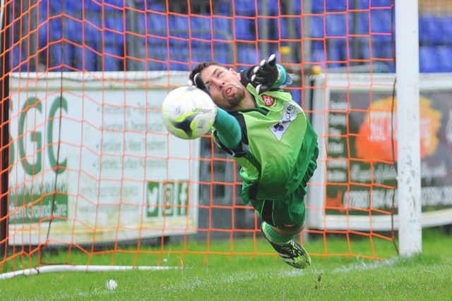 Portchester keeper Leon Pitman makes a great early save from Ben Anderson's free-kick. Picture: Martyn White