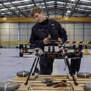 Sailors from 700X Naval Air Station have designed, built and tested their own drone. The large quadcopter called Walrus will be used a testing platform for sensors and other payloads. Pictured with the Walrus is Lieutenant Kristian Lilley.