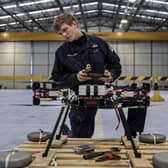 Sailors from 700X Naval Air Station have designed, built and tested their own drone. The large quadcopter called Walrus will be used a testing platform for sensors and other payloads. Pictured with the Walrus is Lieutenant Kristian Lilley.