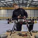 Sailors from 700X Naval Air Station have designed, built and tested their own drone. The large quadcopter called Walrus will be used a testing platform for sensors and other payloads. Pictured with the Walrus is Lieutenant Kristian Lilley.