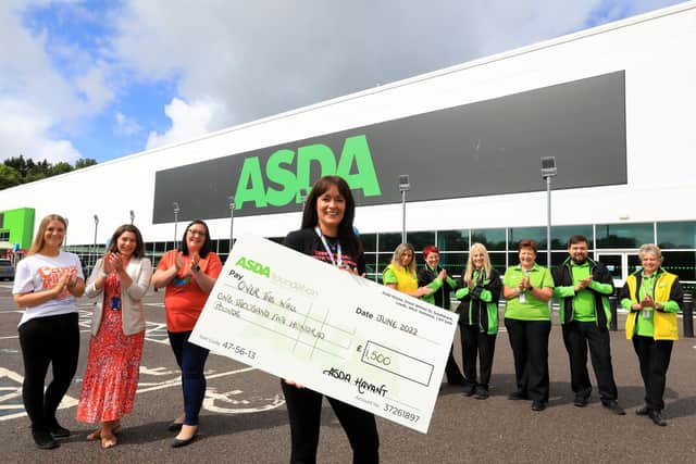 Asda's Katy Trapani, centre, with Becca White, left, Emma Graver, second left, Emma Cannon, third left, all of the charity, and Asda staff. Staff from Asda Havant present a cheque to Over The Wall children's charity on behalf of the Asda Foundation
Picture: Chris Moorhouse (jpns 290622-05)
