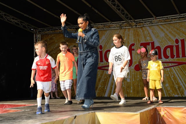 Children join a singer to dance on stage.
Picture: Keith Woodland