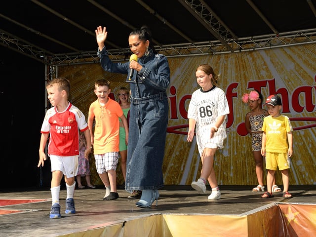 Children join a singer to dance on stage.
Picture: Keith Woodland