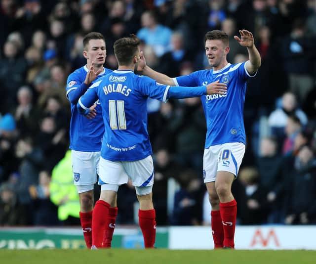 Tom Craddock is congratulated by Jed Wallace and Ricky Holmes after scoring against Scunthorpe in November 2013. Picture: Joe Pepler