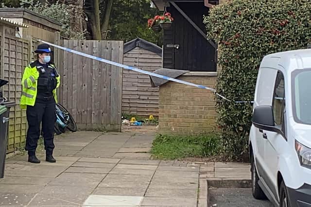An officer stands guard outside a property in Tunstall Road, Paulsgrove, where a man was found seriously injured in a garden. Photo: Tom Cotterill