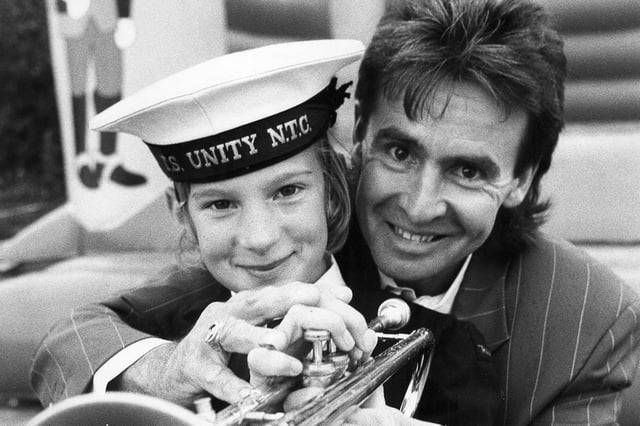 Former Monkee Davy Jones, who lived at Denmead, with young musician Joanne Thompson (10) from the TS Unity Band, Emsworth, in October 1990. Picture: The News 3611-2
