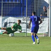 Roux Hardcastle saves a penalty against Horndean in the FA Cup last August - he saved two more spot-kicks as Baffins beat Stoneham to progress to the semi-finals of the Wessex League Cup. Picture: Neil Marshall