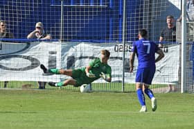 Roux Hardcastle saves a penalty against Horndean in the FA Cup last August - he saved two more spot-kicks as Baffins beat Stoneham to progress to the semi-finals of the Wessex League Cup. Picture: Neil Marshall