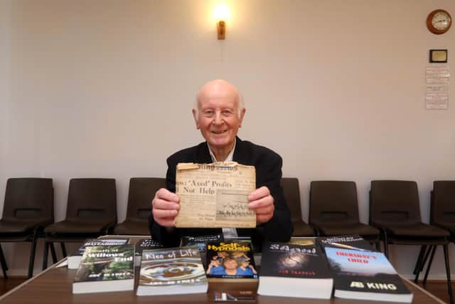 Tony is holding one of his first books he wrote back in 1948 and the book is covered with a copy of The News. Picture: Sam Stephenson