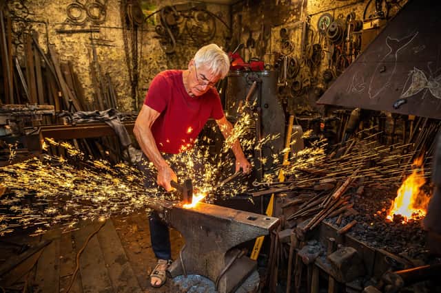 Blacksmith Peter Clutterbuck at work in his Southsea forge. Picture: Mike Cooter (291021)