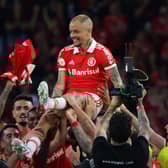 The 41-year-old Andres D'Alessandro is lifted by Internacional team-mates at the end of his last match as professional footballer on Sunday. Picture: SILVIO AVILA/AFP via Getty Images