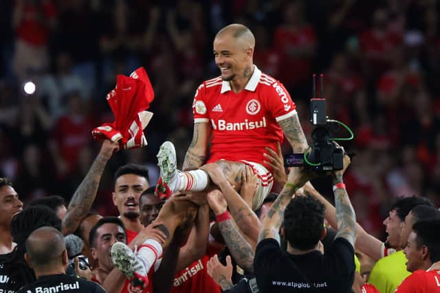 The 41-year-old Andres D'Alessandro is lifted by Internacional team-mates at the end of his last match as professional footballer on Sunday. Picture: SILVIO AVILA/AFP via Getty Images
