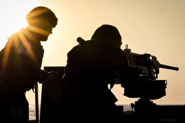 A Royal Navy gunner manning a Heavy Machine Gun on the ships flight deck during a training serial. Picture: PO Phot Lee Blease/Royal Navy.