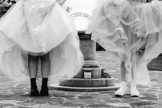 Evie Tikner and Lily Drennan wearing boots and trainers beneath their prom dresses. Picture: Sophia Benham, Beside The Seaside Photography