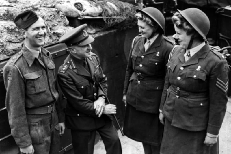 General Sir Frederick Pile (second left), Commander in Chief of the Anti-Aircraft Command, congratulating ATS spotters Private Rene Bolland (second right) and Sergeant Hazel Tester (right) after a Messerschmitt 109 aircraft was shot down off Portsmouth, England, October 12th 1943. (Photo by Central Press/Hulton Archive/Getty Images)