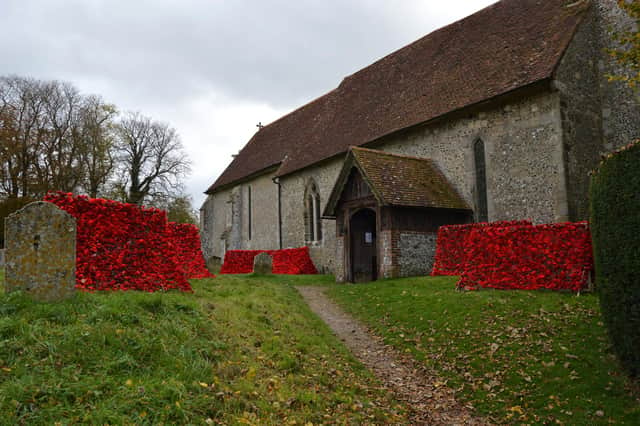 The cascades of poppies that have been arranged inside/outside St Michael and All Angels' Church, Chalton, as part of the ‘Remembering’ exhibition.