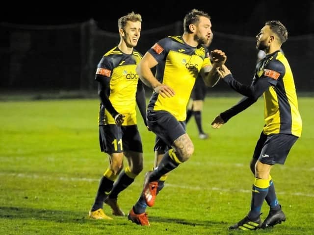 Steve Hutchings (middle) celebrates his opening goal at Alresford last night. Picture: Dave Bodymore.